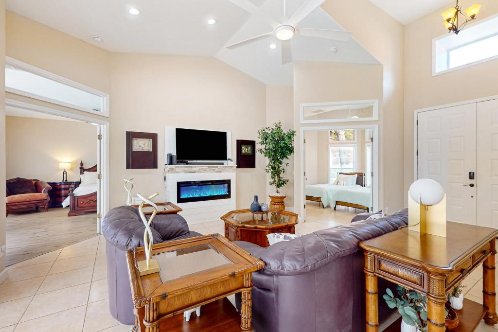 a living room with a couch and a tv at Golfer's Oasis w/ Pool in Black Diamond Ranch! in Lecanto