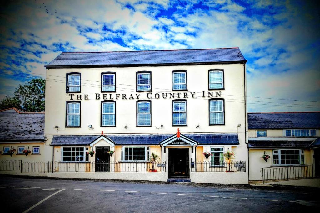a large white building with the library country inn at The Belfray Country Inn in Derry Londonderry