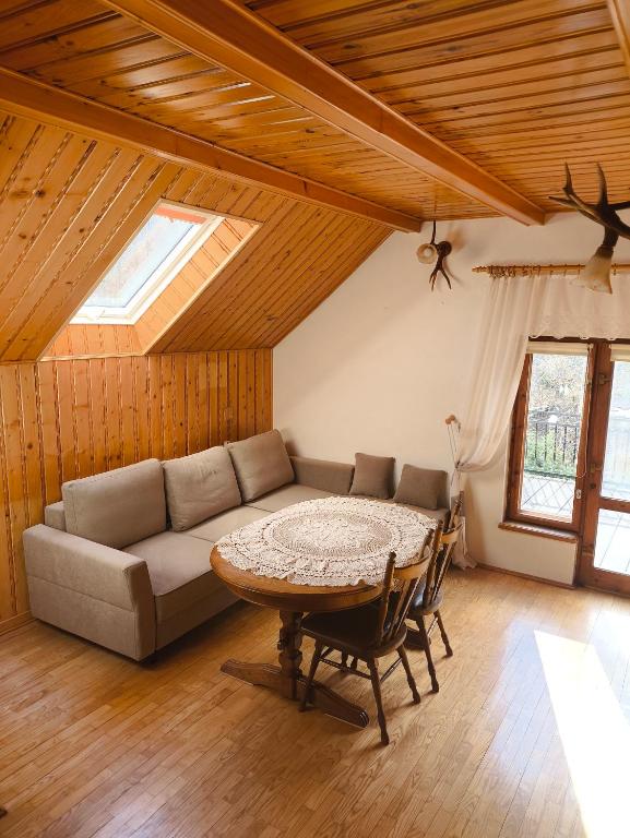 a living room with a couch and a table at Agroturystyka - POD DWOREM in Jureczkowa