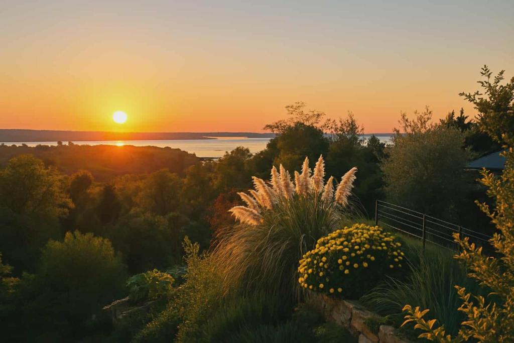 a view of the sunset from a garden at OleaVista in Portorož