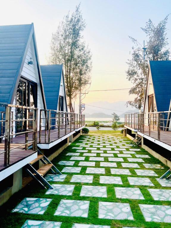 a walkway between two cottages with a patio at Mia's Homestay in Quang Ninh
