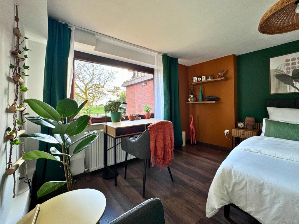 a bedroom with a bed and a desk and a window at Weserblick Hafen-Haus-Bremen in Bremen