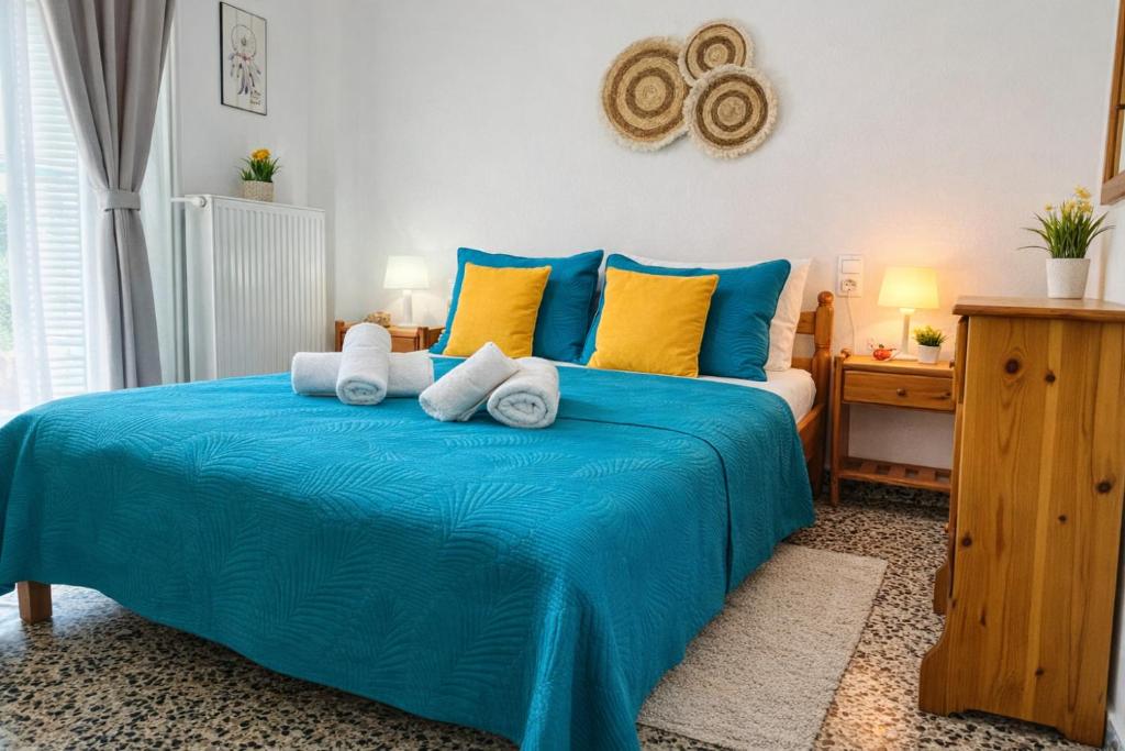 a bedroom with a blue bed with towels on it at Skiathos home with the best view in Skiathos