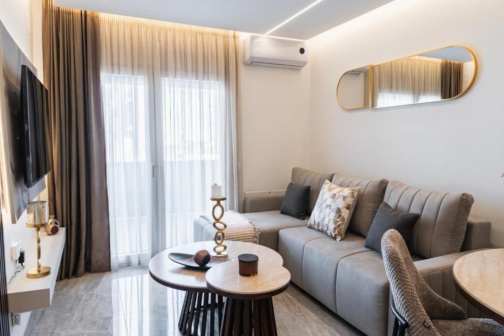 a living room with a couch and a table at Oniro Suites Level 4 in Alexandroupoli
