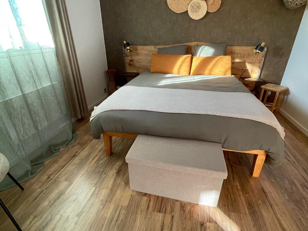a bedroom with a bed and a large window at Chez Fab in Ferrières-lès-Ray