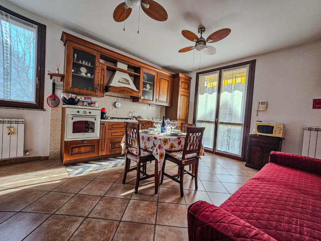 a kitchen with a table and chairs and a couch at Malpensa Retreat in Ferno