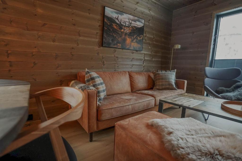 a living room with a couch and a table at Mountain View Apartment 201 in Stranda