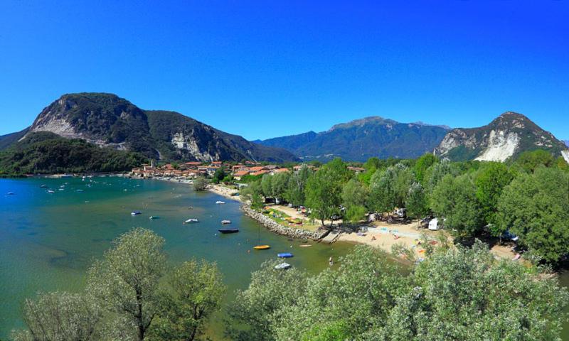 a view of a beach with boats in the water at Paradiso sul Lago Maggiore in Baveno