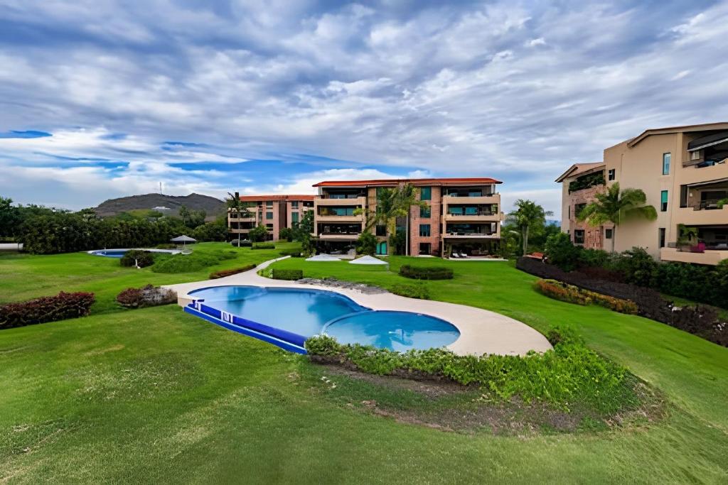 an image of an apartment complex with a swimming pool at Punta Mita 4BR Paradise Golf Course Views in Punta Mita