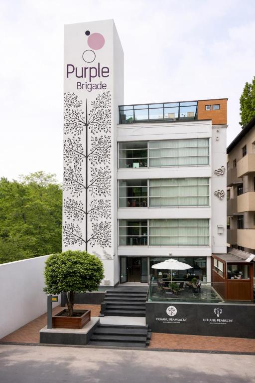 a building with a sign on the side of it at Purple Brigade, Bangalore in Bangalore