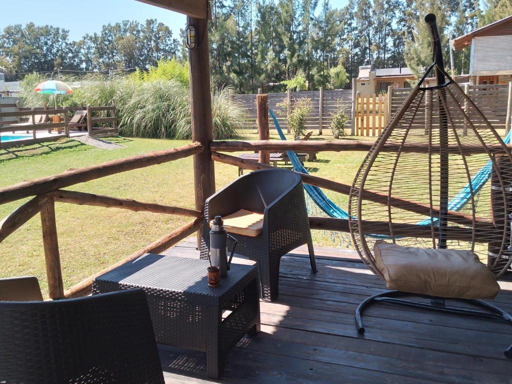 a porch with a hammock and a swing at Cabañas Campos del Parana in San Pedro