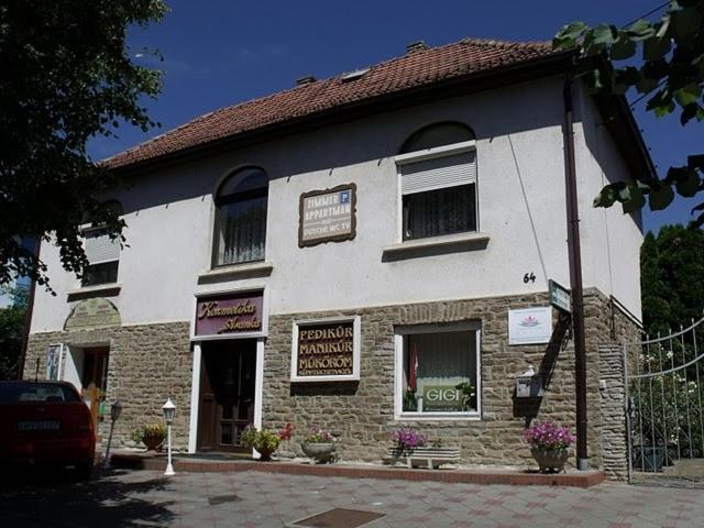 a building with a sign on the front of it at Magdi Panzió in Hévíz