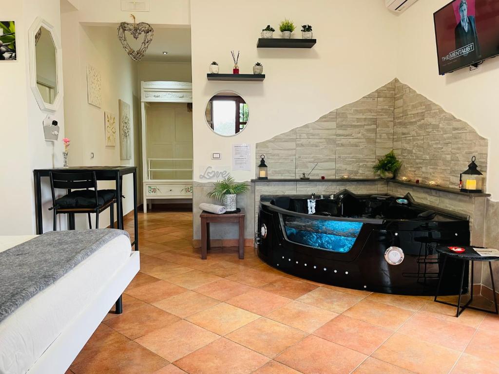 a bedroom with a bed and a bath tub at Room24 Relax & Wellness in Genzano di Roma