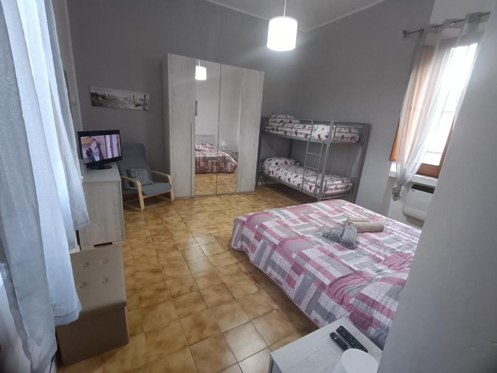 a bedroom with a bed and a table and a mirror at A casa di Irene in Le Marmore
