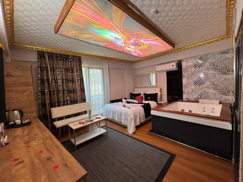 a bedroom with a bed and a tub in a room at İstanbul Royal Hotel Kumkapı in Istanbul