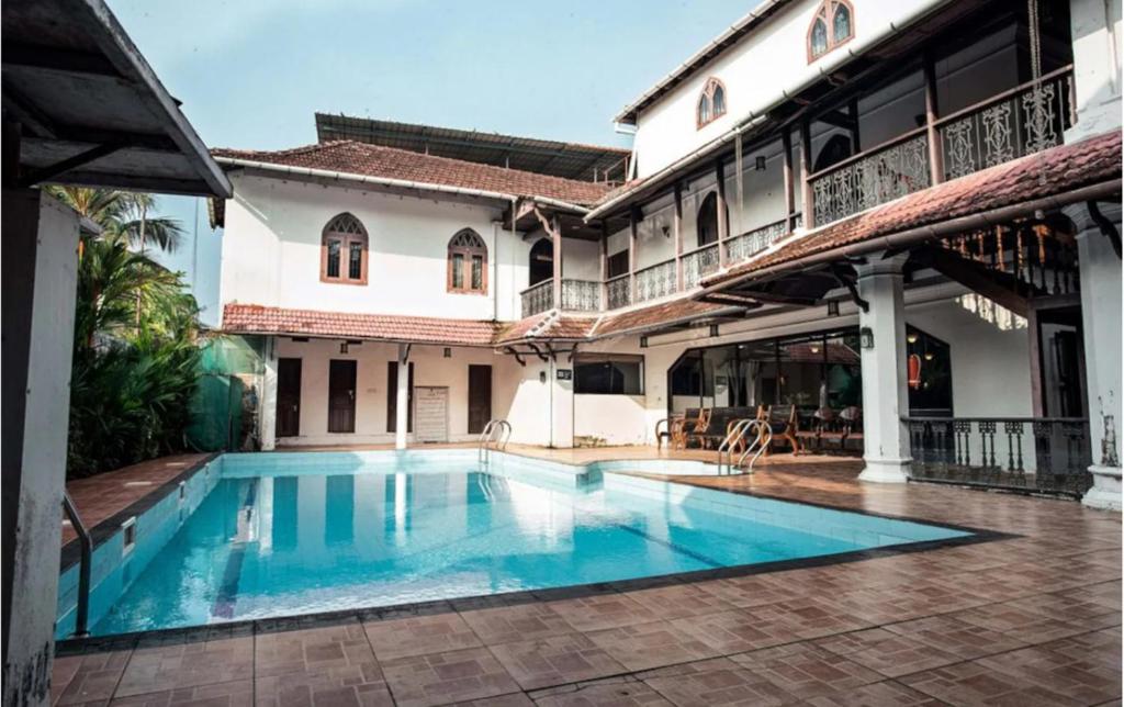 a swimming pool in front of a building at The Heritage Kochi in Cochin