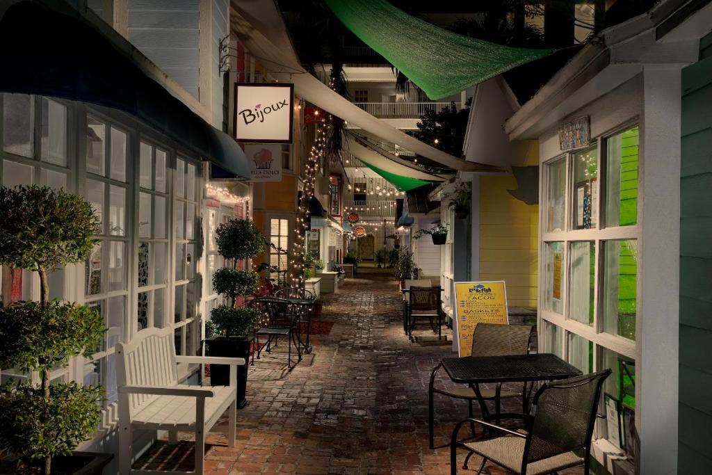 an alley with tables and chairs in a building at Olde Marco Island Inn and Suites in Marco Island