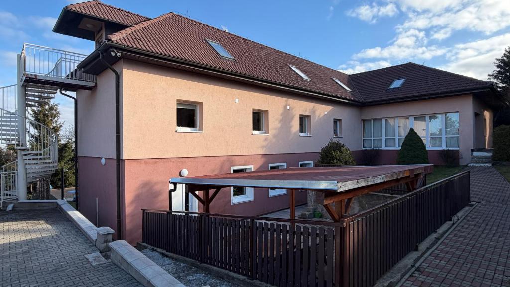 a house with a large deck in front of it at Ubytování Divišov in Divišov