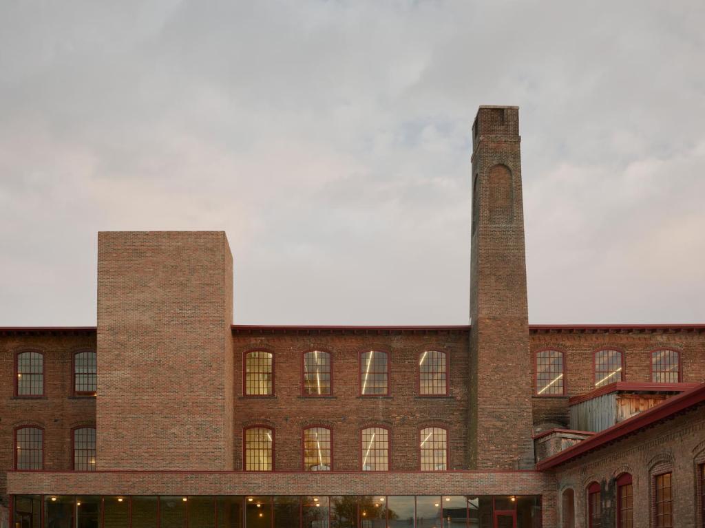 two towers on the side of a brick building at Pocketbook Hotel and Baths in Hudson
