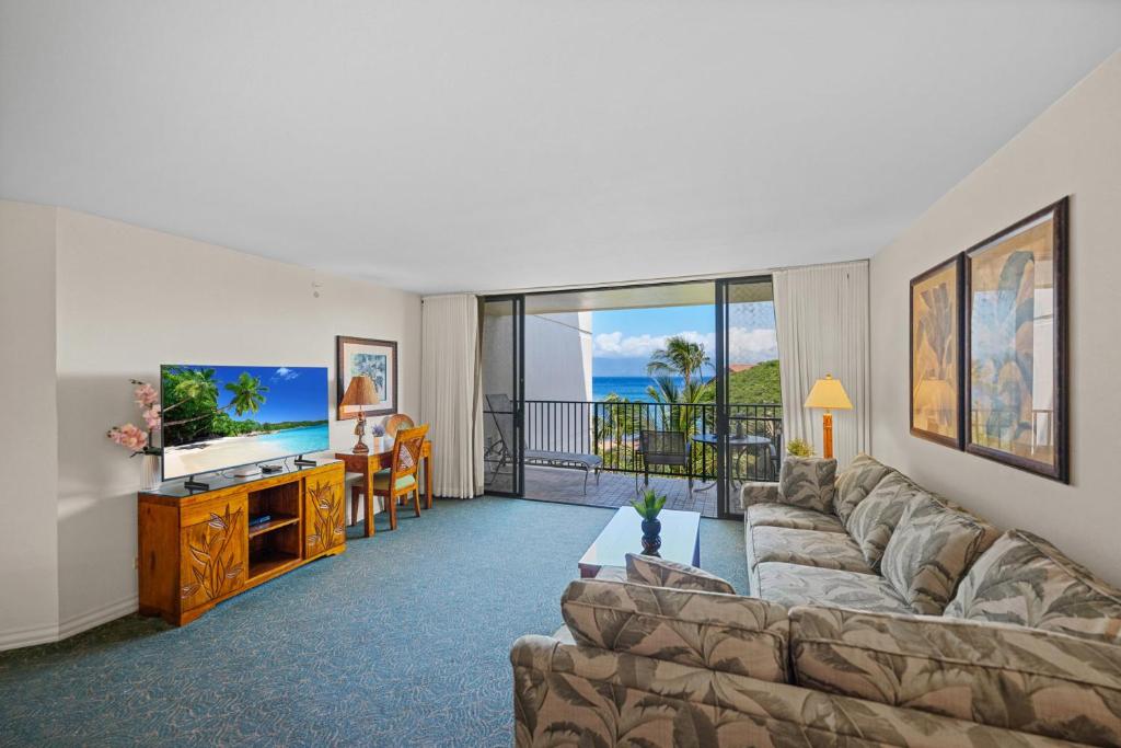 a living room with a couch and a flat screen tv at Kaanapali Shores 512 in Kaanapali