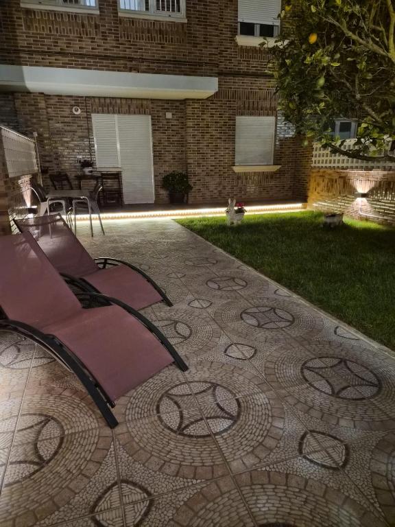 a patio with a chair sitting on the ground at APARTAMENTO COSTA CANTABRIA in Cuchia
