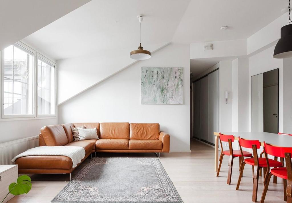 a living room with a couch and a table at Modern Two-Bedroom Apartment with Sauna & Free Parking in Turku