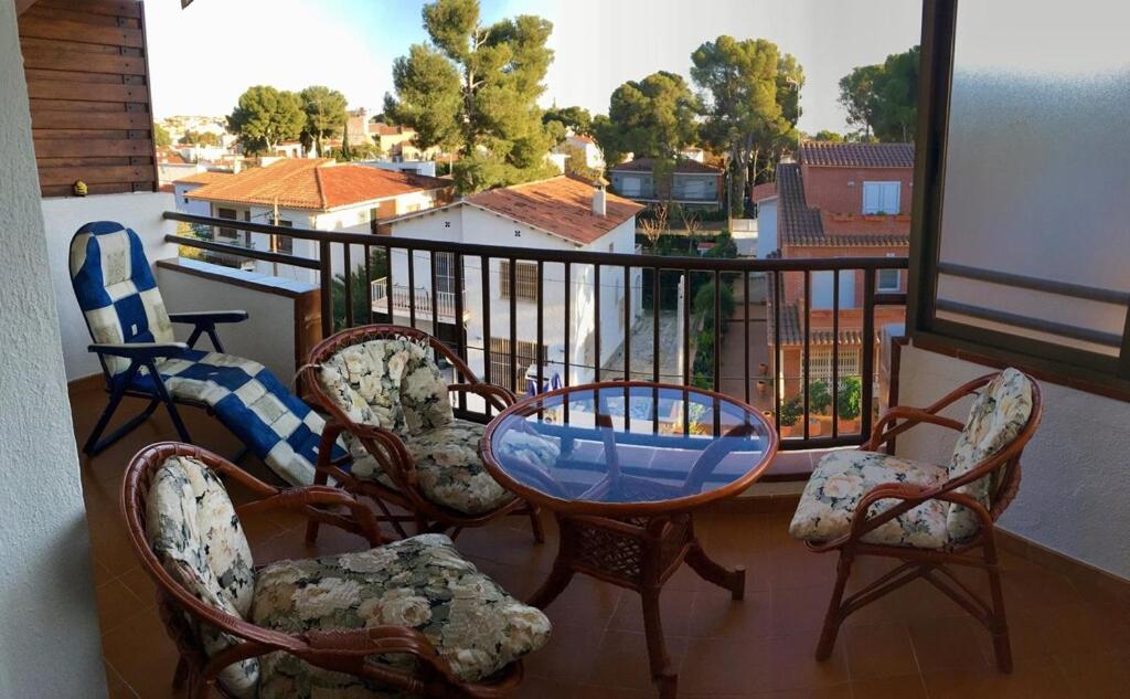 a balcony with a table and chairs on a balcony at Coma-ruga in Comarruga