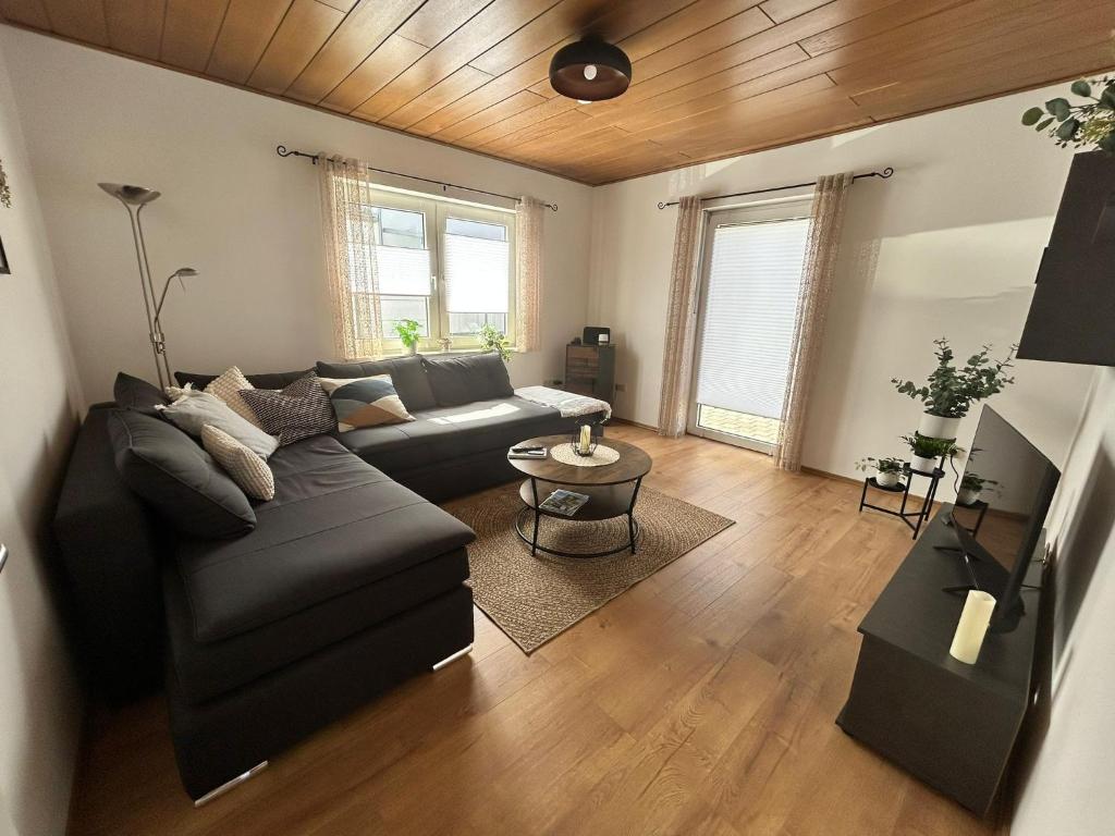 a living room with a couch and a table at Ferienwohnung aufm Weinberg in Schwandorf in Bayern