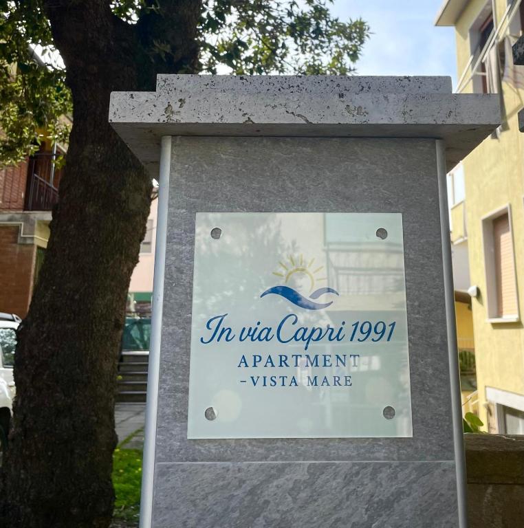a sign in the courtyard of a apartment building at In Via Capri 1991 APARTMENT in Follonica
