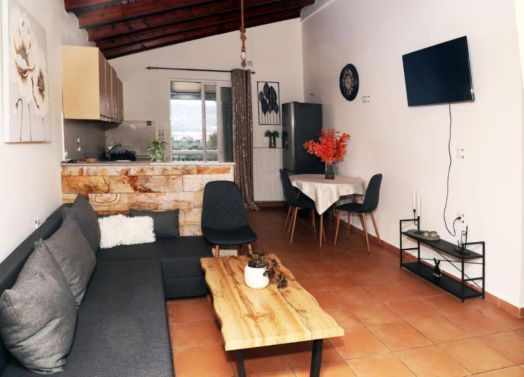 a living room with a couch and a table at AnastasiaSunsetView in Souda
