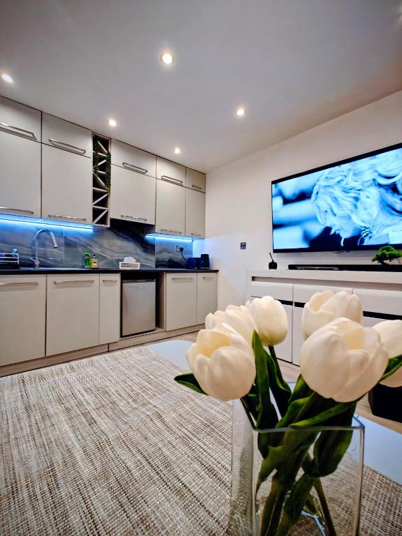 a kitchen with a vase with white flowers in it at Clonakilty Cozy Nest in Clonakilty