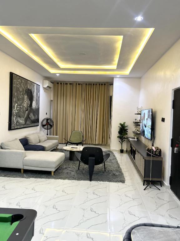 a living room with a couch and a table at Dinems Apartment in Ikeja