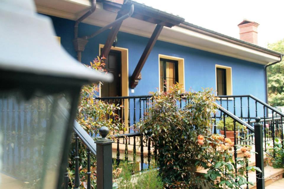 a blue house with a fence in front of it at Apartamentos Rurales Les Mestes in Tazones