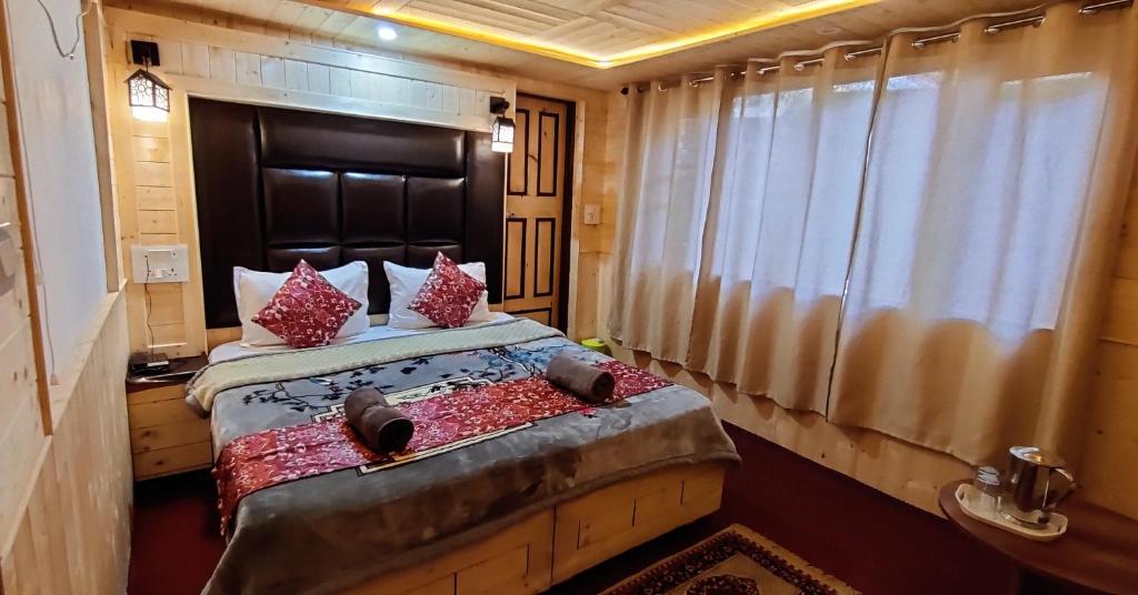a bedroom with a bed and a window at K2 Alpine Hotel in Pahalgām