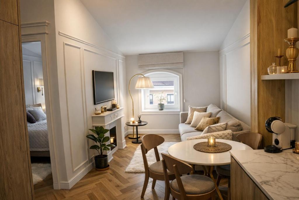 a living room with a couch and a table at Oficyna Drukarza in Wschowa