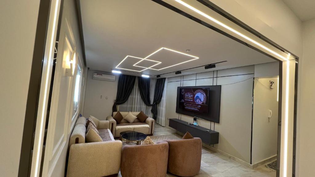 a living room with a couch and a tv at دمياط الجديدة جنة مصر in Dumyāţ al Jadīdah