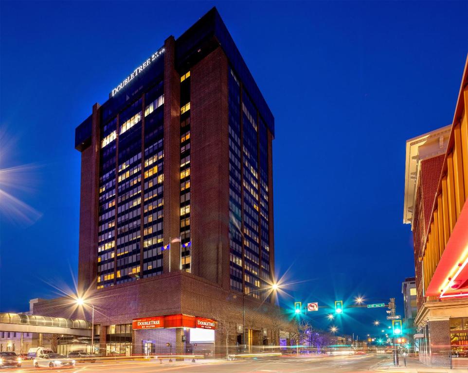 a tall building on a city street at night at Doubletree By Hilton Billings in Billings