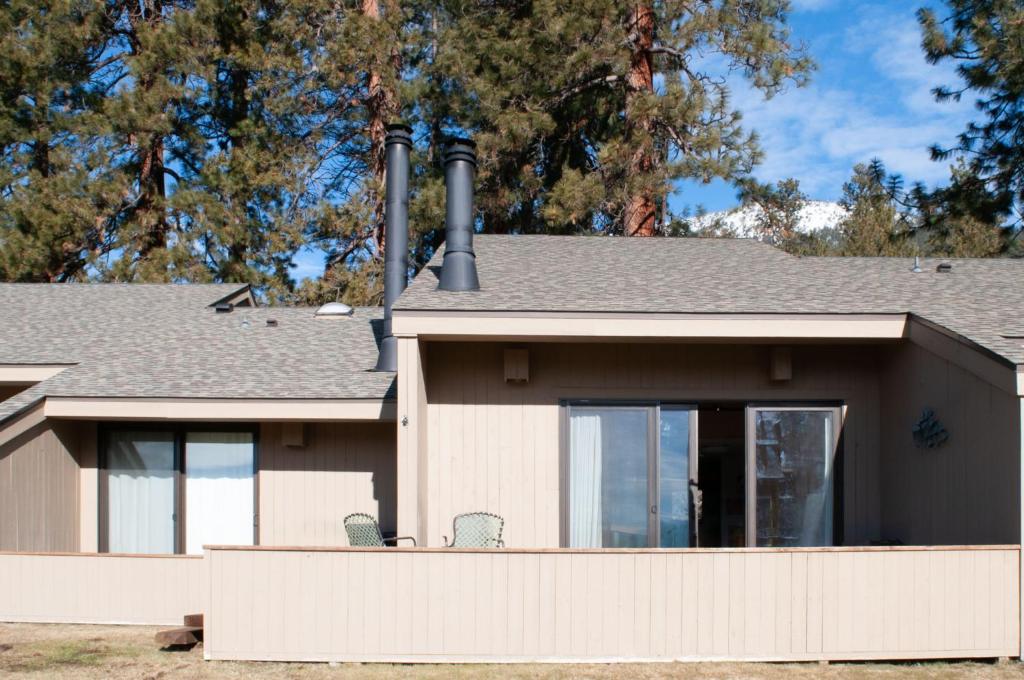 a house with a fence in front of it at Lodge Condo 004 in Black Butte Ranch
