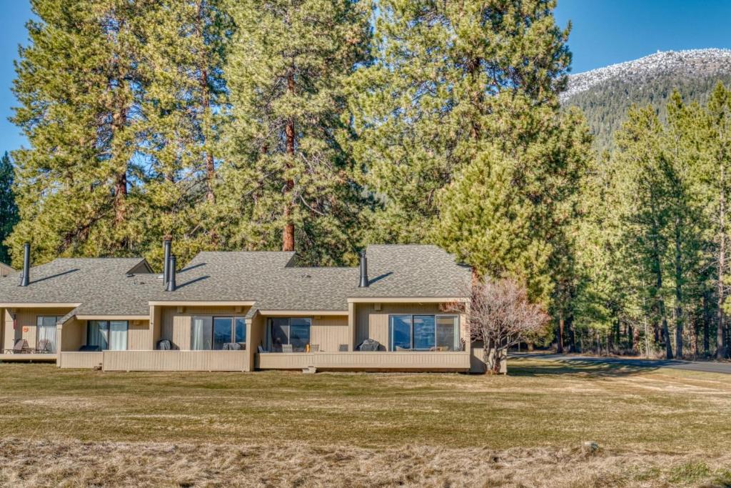 a house on a field with trees at Lodge Condo 001 in Black Butte Ranch