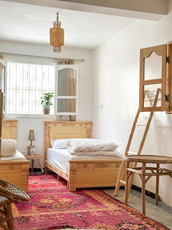 a bedroom with a bed and a ladder and a mirror at Surf and Stay Anza - Surf Territory in Agadir
