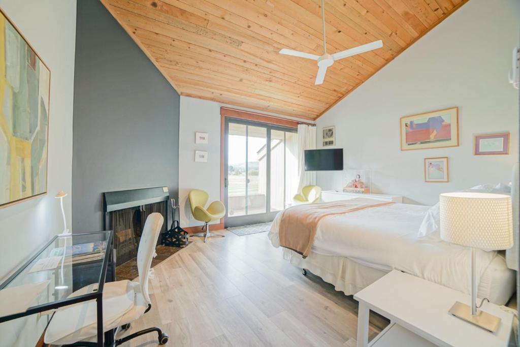 a bedroom with a bed and a desk and a fireplace at Lodge Room 005 in Black Butte Ranch