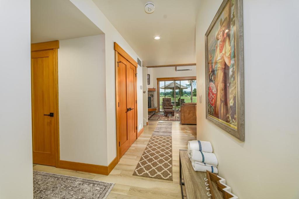 a hallway with a couch and a painting on the wall at Lodge Condo 036 in Black Butte Ranch