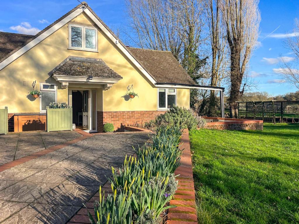 a yellow house with a driveway and green grass at Island House - Uk51001 in Little Baddow