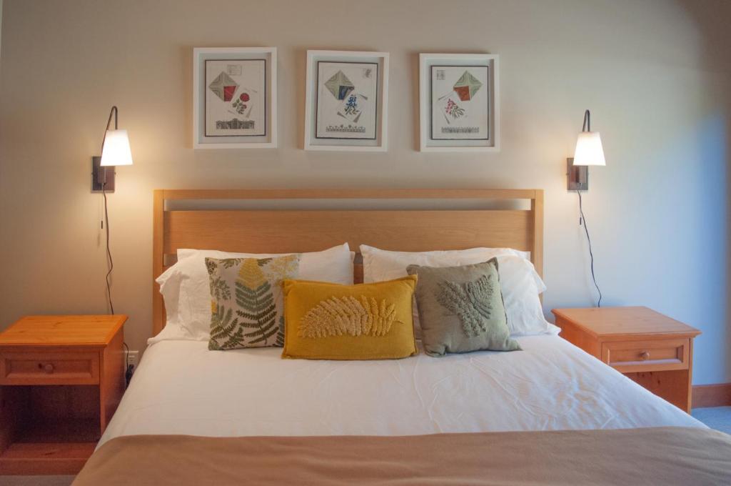 a bedroom with a bed with pillows and two lamps at Lodge Room 016 in Black Butte Ranch