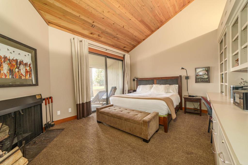 a bedroom with a bed and a fireplace at Lodge Room 023 in Black Butte Ranch