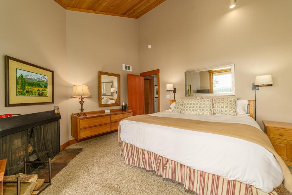 a bedroom with a large bed and a fireplace at Lodge Room 020 in Black Butte Ranch