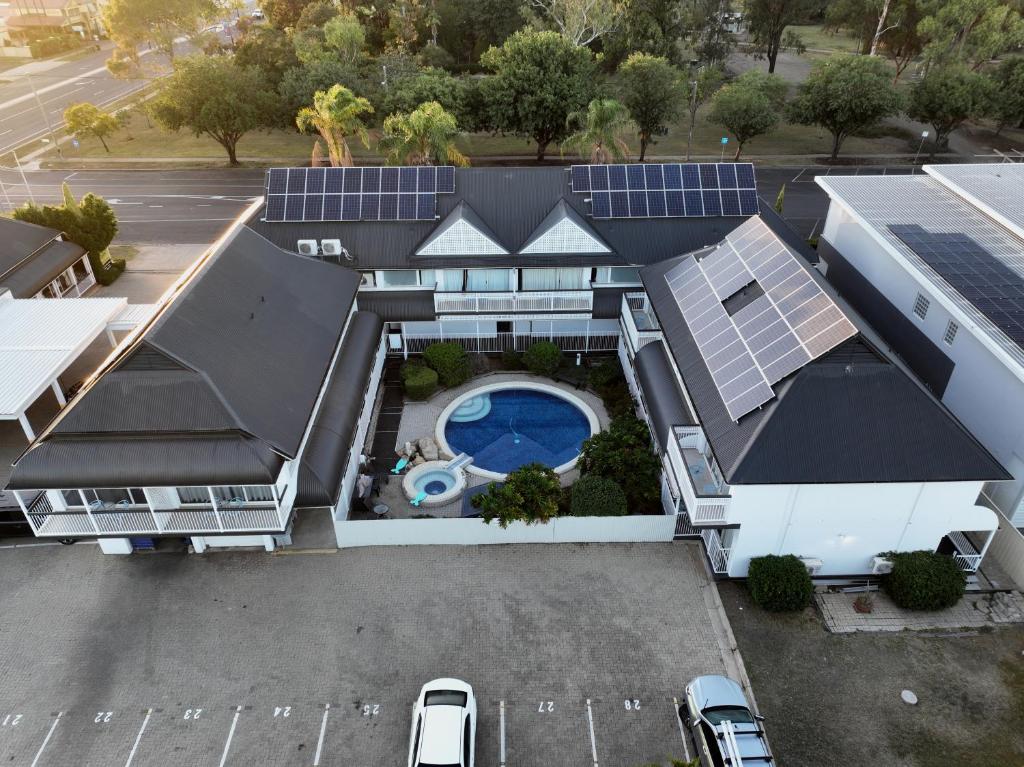 an aerial view of a house with solar panels on it at Dalby Manor Motor Inn in Dalby