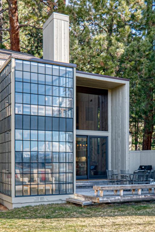 a modern house with glass windows and a patio at Country House 073 in Black Butte Ranch