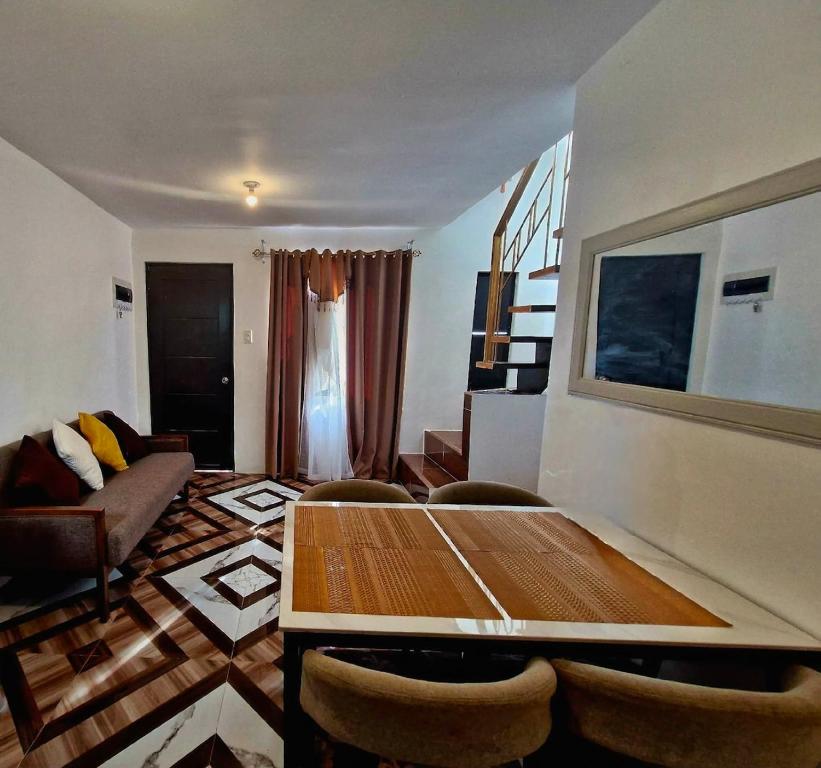 a living room with a wooden table and chairs at JO's HOMEtel SL 1 in Sampong