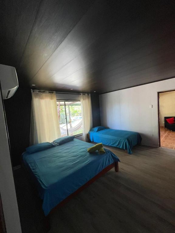 a bedroom with two beds and a window at Paraiso Playa in Cartagena de Indias